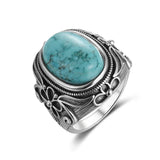 Bague ancienne en argent 925 avec une pierre ovale Turquoise et des motifs floraux.