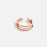 Bague orteil en acier à triple anneau, de couleur rose gold à taille ajustable.