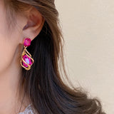 boucle d'oreille fushia