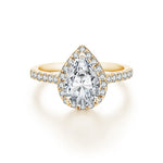 Bague or 18 carats avec une moissanite taillée en poire toute entourée de petites pierres.