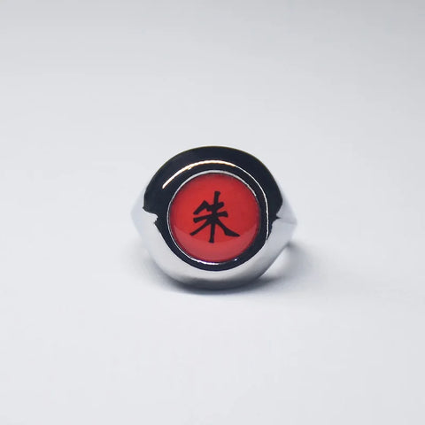 Bague Akatsuki avec l'anneau de couleur argent et une pierre rouge au centre avec un kanji noir.
