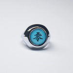 Bague Akatsuki avec l'anneau de couleur argent et une pierre bleue avec un kanji noir.
