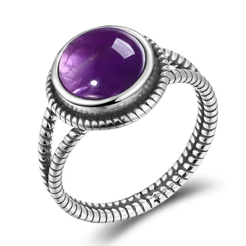 Bague améthyste en argent sterling 925 avec une pierre ovale et une monture torsadée.