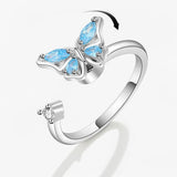 Bague anti stress femme avec un papillon bleu à mécanisme rotatif.