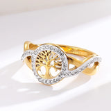 Bague arbre de vie dorée en acier inoxydable avec un médaillon ajouré et des cristaux.