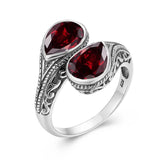 Bague argent 925 sterling avec un anneau à motifs et deux rubis.