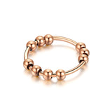 Bague d'anxiété en acier inoxydable couleur rose gold à perles rotatives.