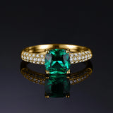 Bague de fiançailles émeraude en argent 925 doré, une émeraude verte et de petites pierres sur l'anneau.
