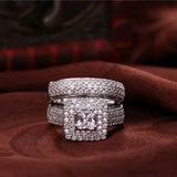 Bague de fiançailles et alliance assorties, les deux sont en argent 925 et décorés de petits zircones, l'une possède une pierre centrale carrée.