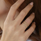 Bague dorée femme en acier inoxydable portée sur l'annulaire d'une femme.