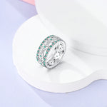 Bague argent 925 avec deux rangées de petites fleurs et une rangée de zircones de couleur turquoise.