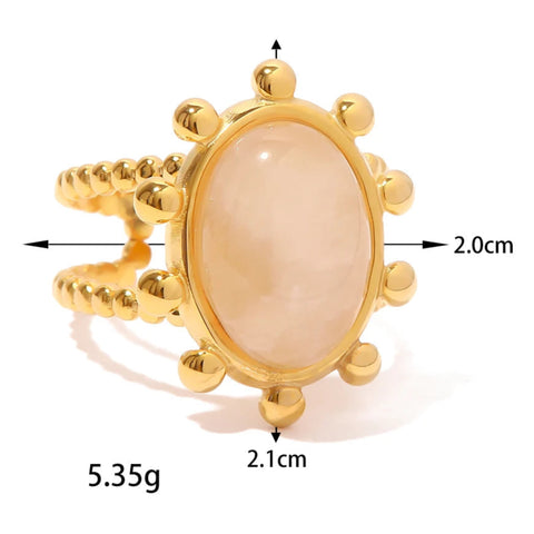 Bague femme pas cher dorée à double anneau avec une pierre rose ovale ornée de petites boules dorées.