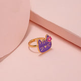 Bague fille en alliage de zinc doré avec un pendentif chat violet.