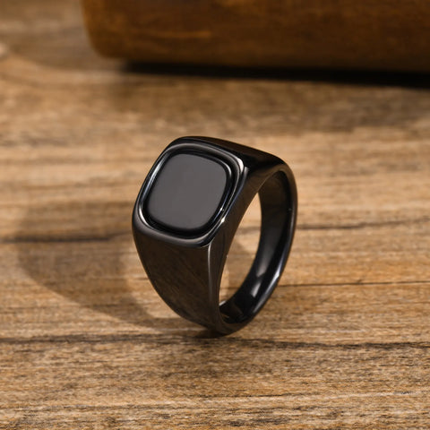 Bague homme noire en acier inoxydable avec une pierre incrustée carrée.