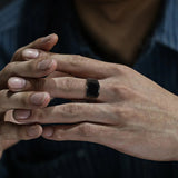 Homme portant une bague homme noire en acier inoxydable sur son majeur.