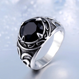 Bague pour homme argentée avec une pierre centrale noire.