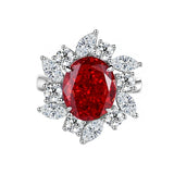Bague rubis diamant avec un rubis ovale entouré de zircones formant des pétales.