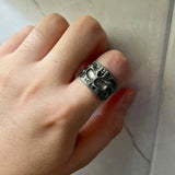 Bague tete de mort homme couleur argenté portée sur l'index d'un homme.