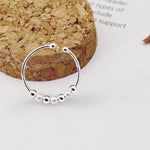 Bague anti stress en argent sterling 925 avec 7 boules rotatives, 4 billes lisses et 3 billes gommées.